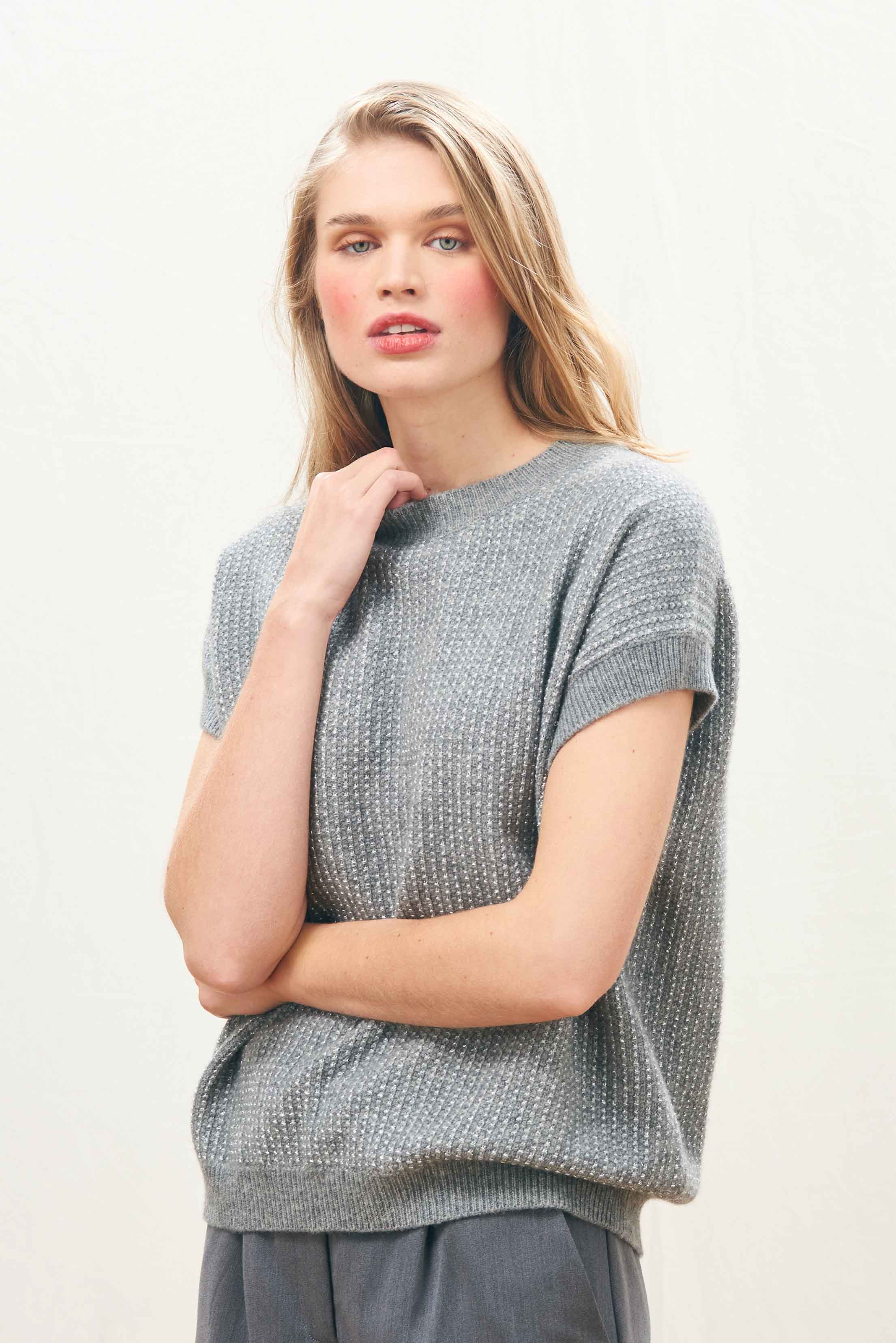 Female model wearing Jumper 1234 Oversize cashmere and wool tank in mid grey with silver lurex running through the birdseye texture.
