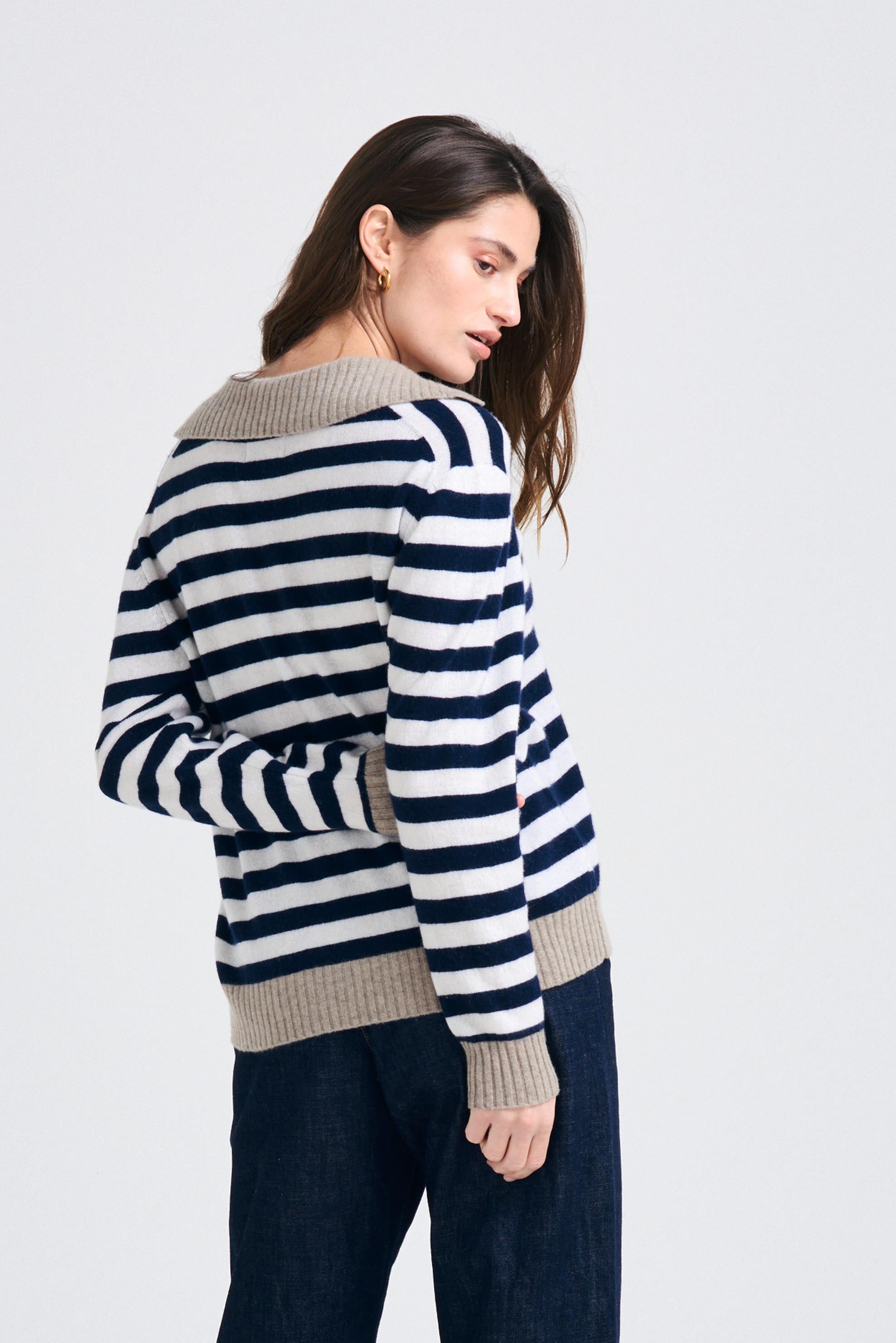 Brown haired female model wearing Jumper1234 Navy and cream stripe cashmere jumper with contrast organic light brown collar and trims facing away from the camera