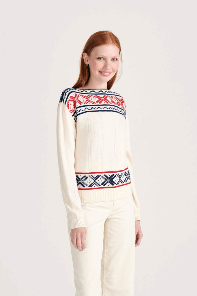 Ginger female model wearing Jumper1234 cream cashmere "greek guernsey" with navy and red hem and yolk detail