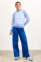 Brown haired female model wearing Jumper1234 blue and cream lightweight merino "Stripe crew" 