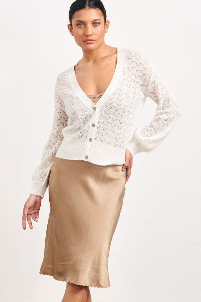 Brown haired female model wearing Jumper1234 cream lightweight merino "Lace cardigan"