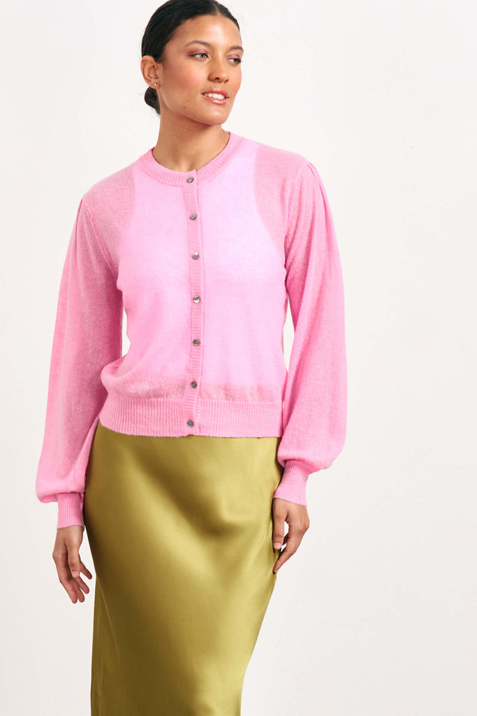 Brown haired female model wearing Jumper1234 pink lightweight merino "Puff Sleeve cardigan" 