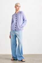 Blonde female model wearing Jumper 1234 cashmere and wool heavier weight round neck cardigan in violet marl
