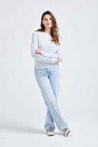 brown haired female model wearing Jumper1234 pale blue lighter weight crew neck cashmere jumper
