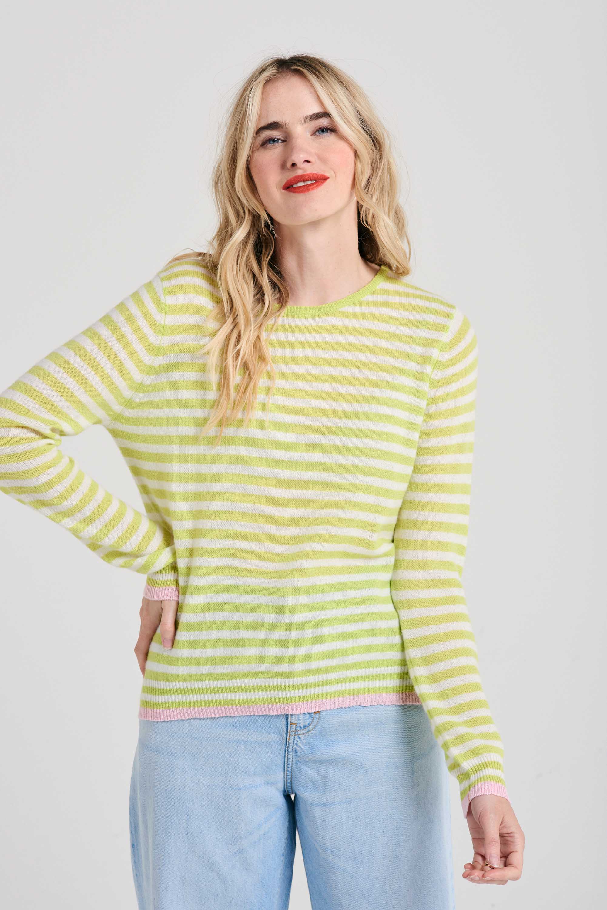 Blonde female model wearing Jumper1234 Little stripe cashmere crew neck jumper in acid green and cream, with pale pink tipped ribs