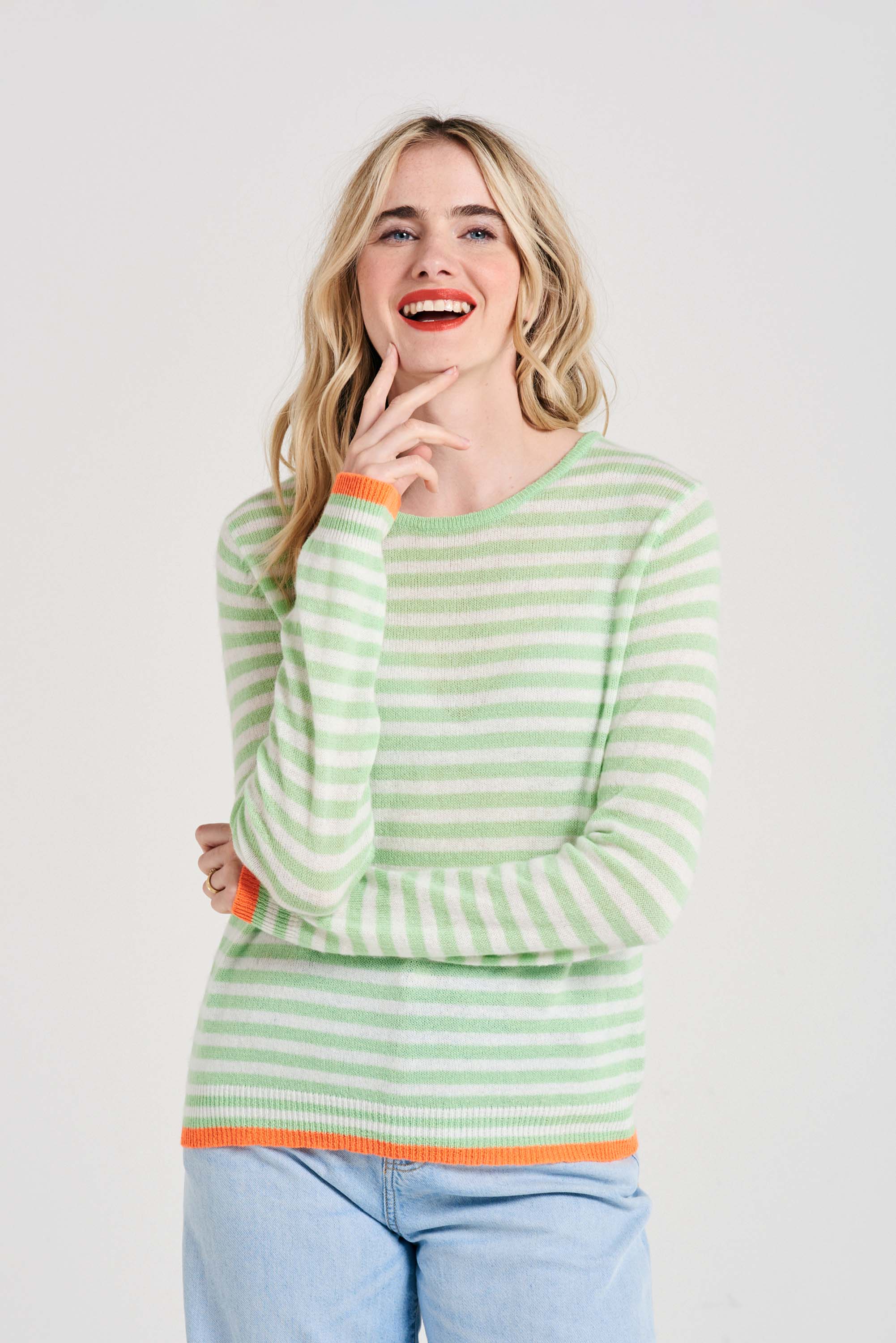 Blonde female model wearing Jumper1234 Little stripe cashmere crew neck jumper in lime green and cream, with neon orange tipped ribs