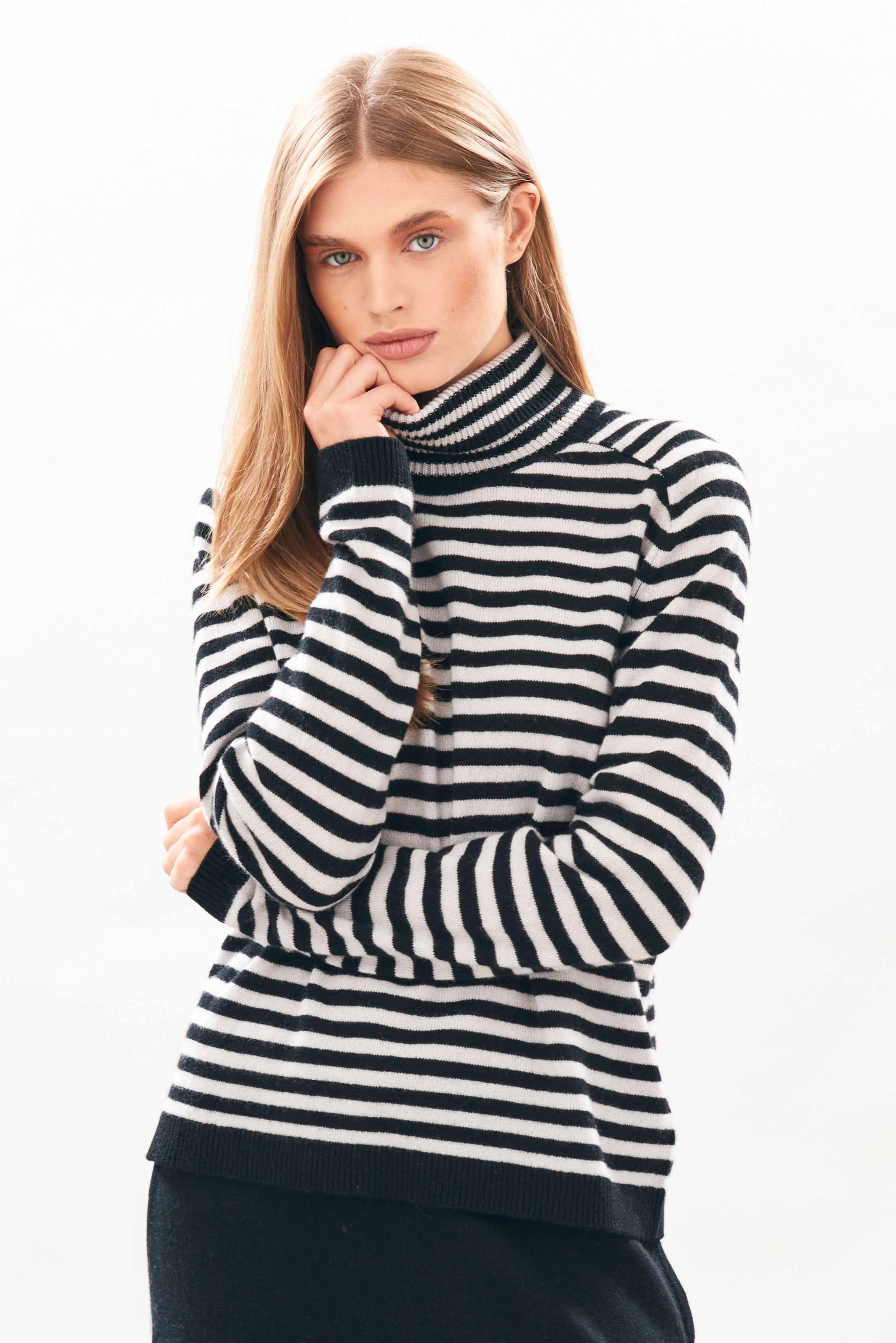 female model wearing jumper1234 Narrow Stripe Cashmere Roll Collar in Black and Fog facing towards the camera