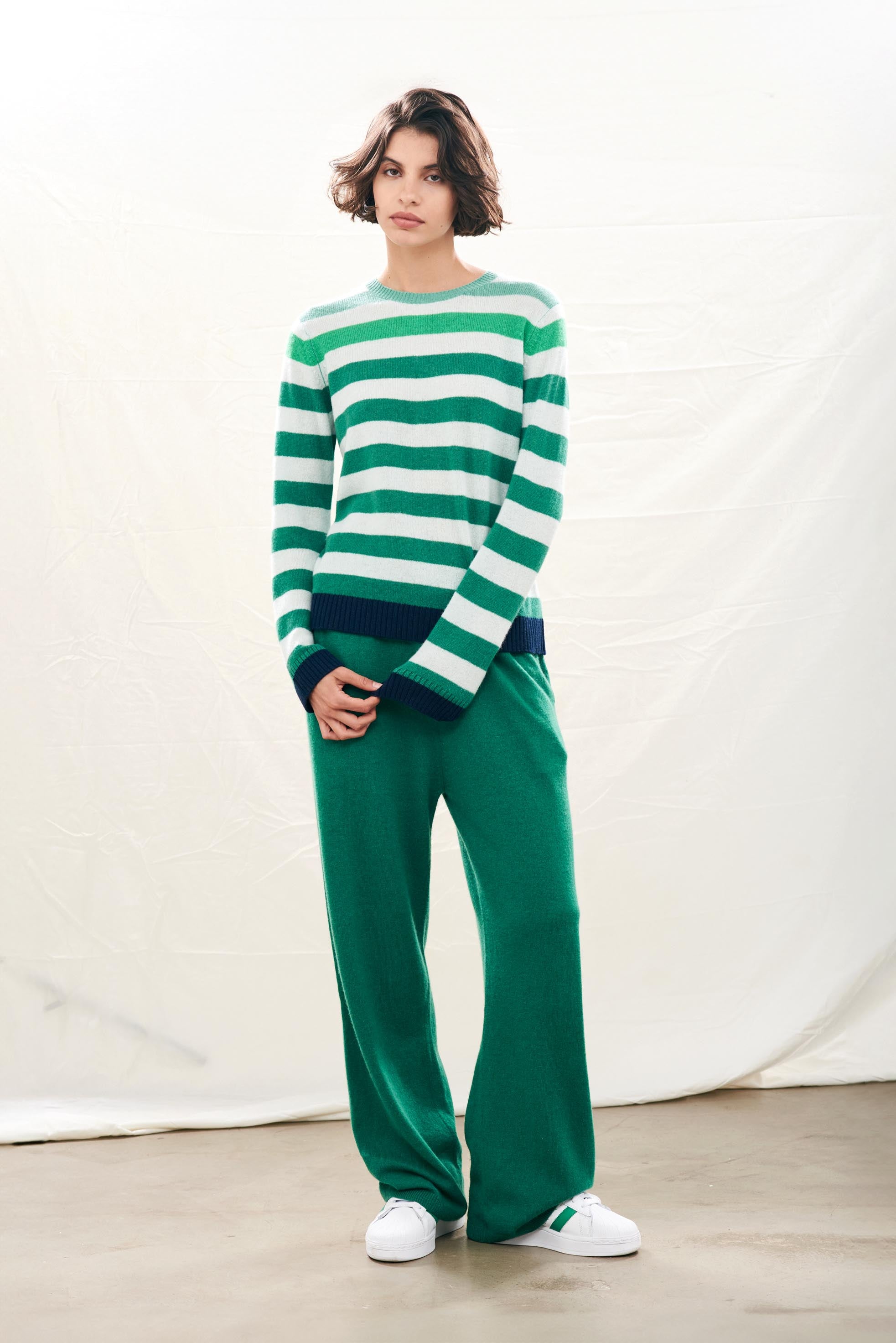 Female model wearing Jumper1234 Cashmere Gradient Stripe Crew in ombre shade of Green with navy ribs