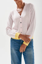 Model wearing Jumper 1234 cashmere pale pink vee neck cardigan with contrast lemon ribs