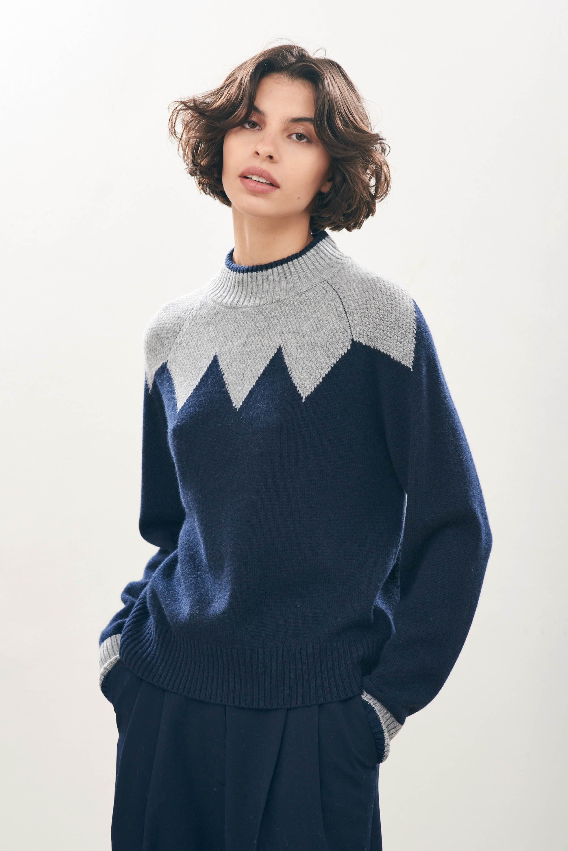 female model wearing Cashmere Wool Zig Zag Turtle in Grey and Navy facing towards the camera 