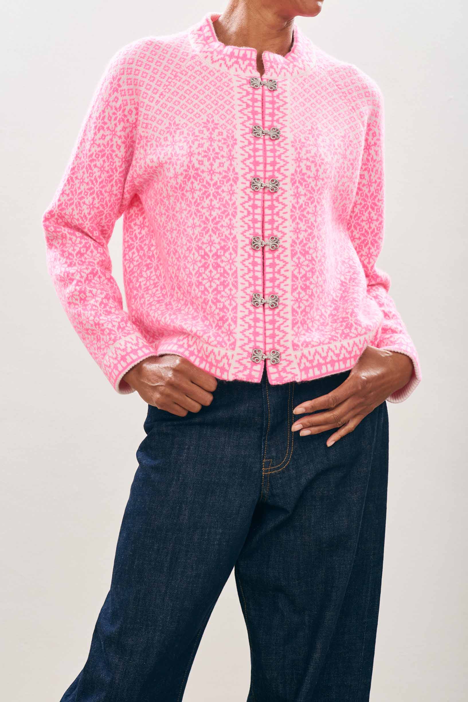 female model wearing jumper1234 Cashmere Wool Norse Cardigan in Cream and Neon Pink close up 