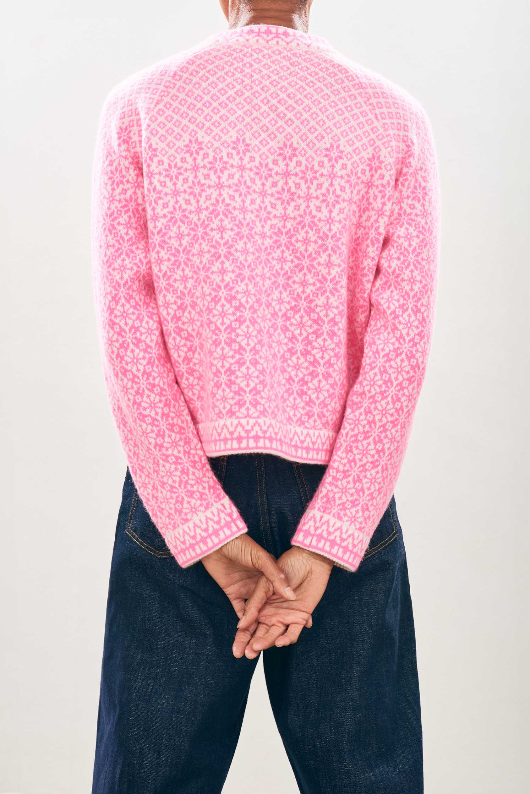 female model wearing jumper1234 Cashmere Wool Norse Cardigan in Cream and Neon Pink facing away from the camera
