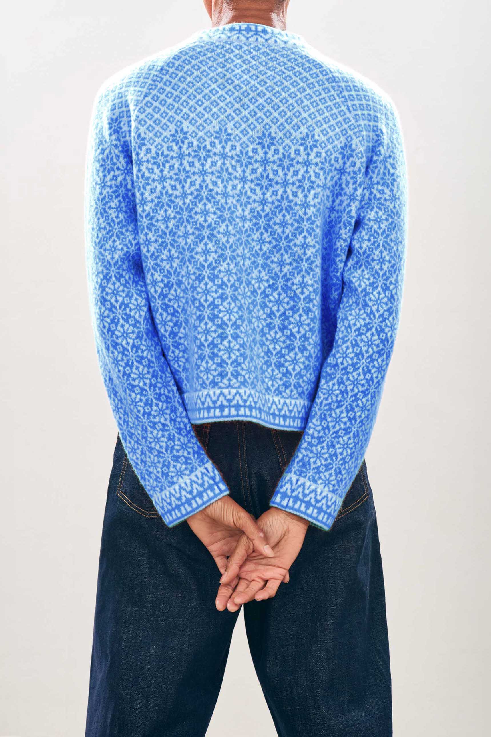 female model wearing jumper1234 Cashmere Wool Norse Cardigan in Cream and Sky facing away from the camera 