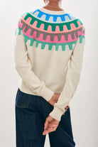 Female model wearing Jumper1234 Cashmere Rick Rack yolk Crew in Cream facing away from the camera