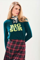 Model wearing Jumper1234 Bottle green cashmere crew neck with acid green 'Big Sur' intarsia