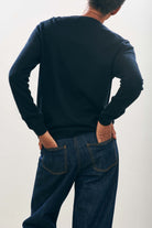 Female model wearing Jumper1234 Cashmere Wanted Crew in Black and Cream facing away from the camera