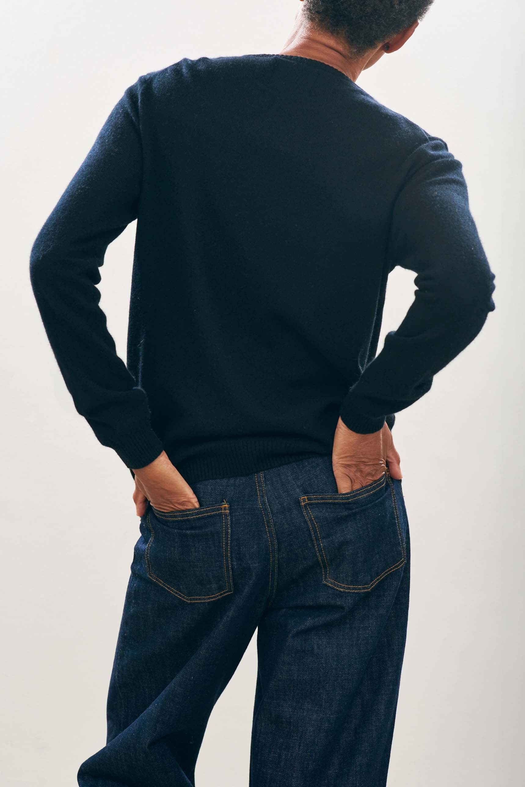 Female model wearing Jumper1234 Cashmere Wanted Crew in Black and Cream facing away from the camera