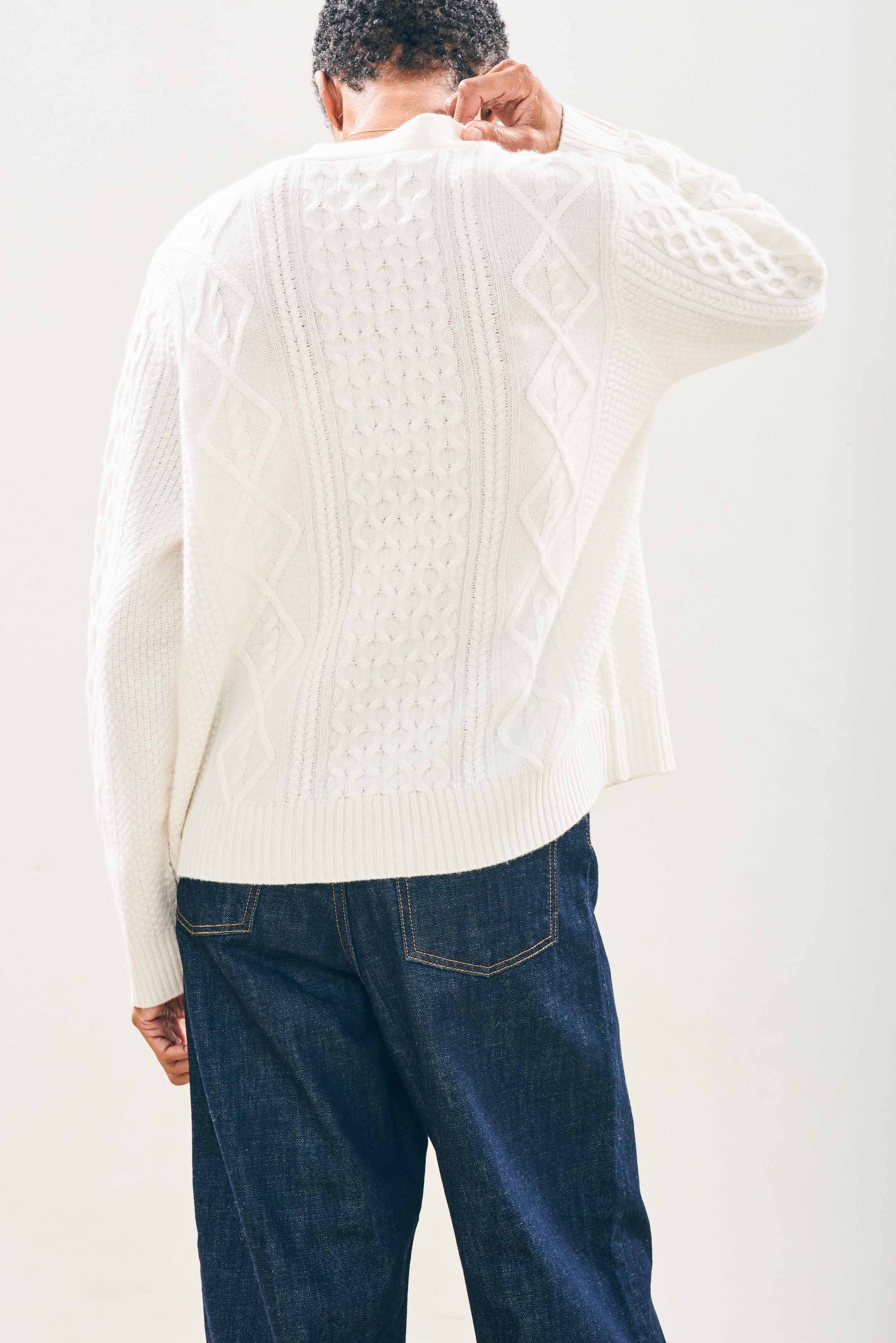 Model wearing Jumper1234 Cashmere Wool Aran Cardigan in Cream facing away from the camera