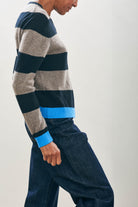 Female model wearing Cashmere Contrast Stripe Crew in Black, Moose and Sky facing sideways to the camera