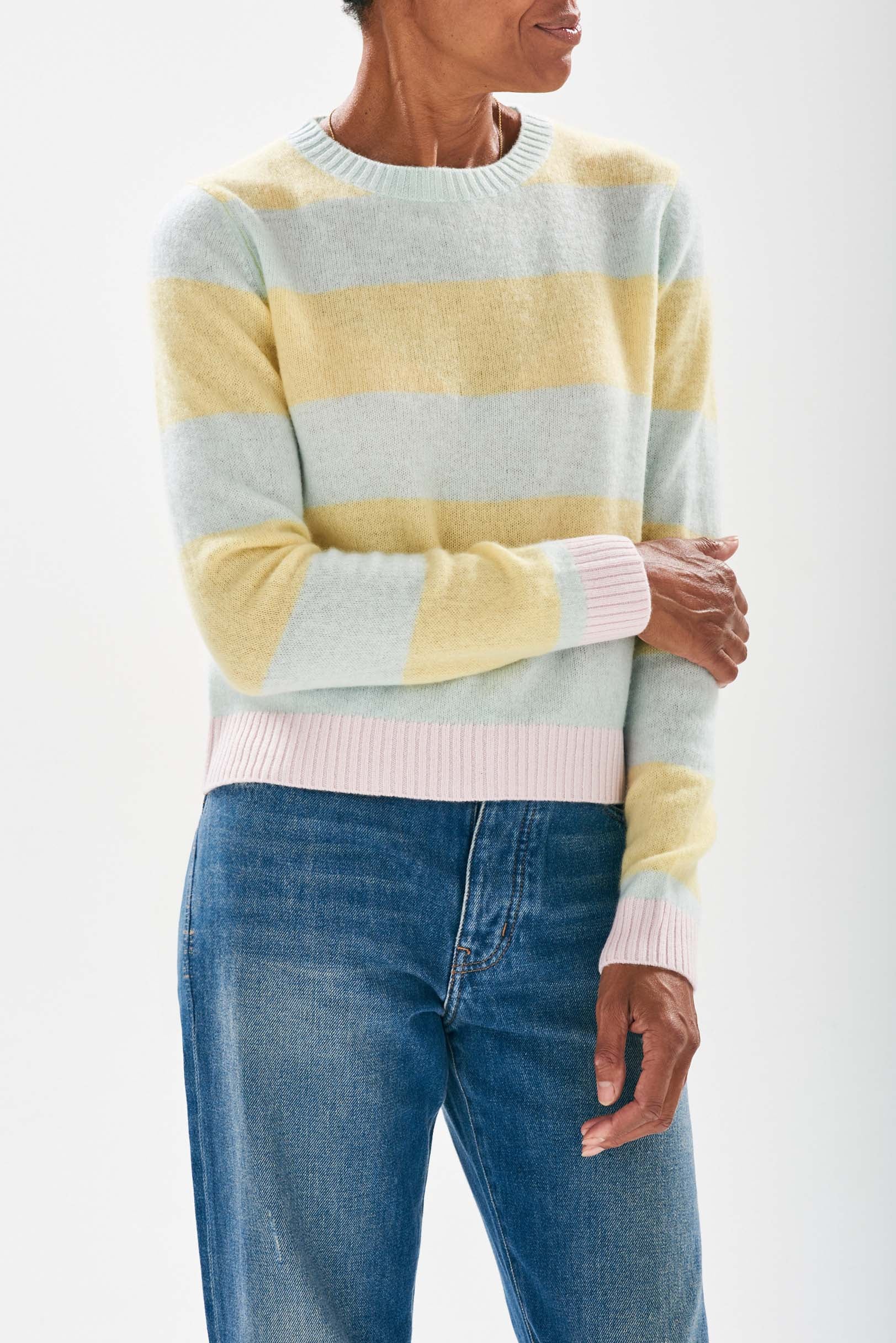 Model wearing Jumper 1234 cashmere pale green and lemon stripe cashmere crew neck with contrast pale pink ribs