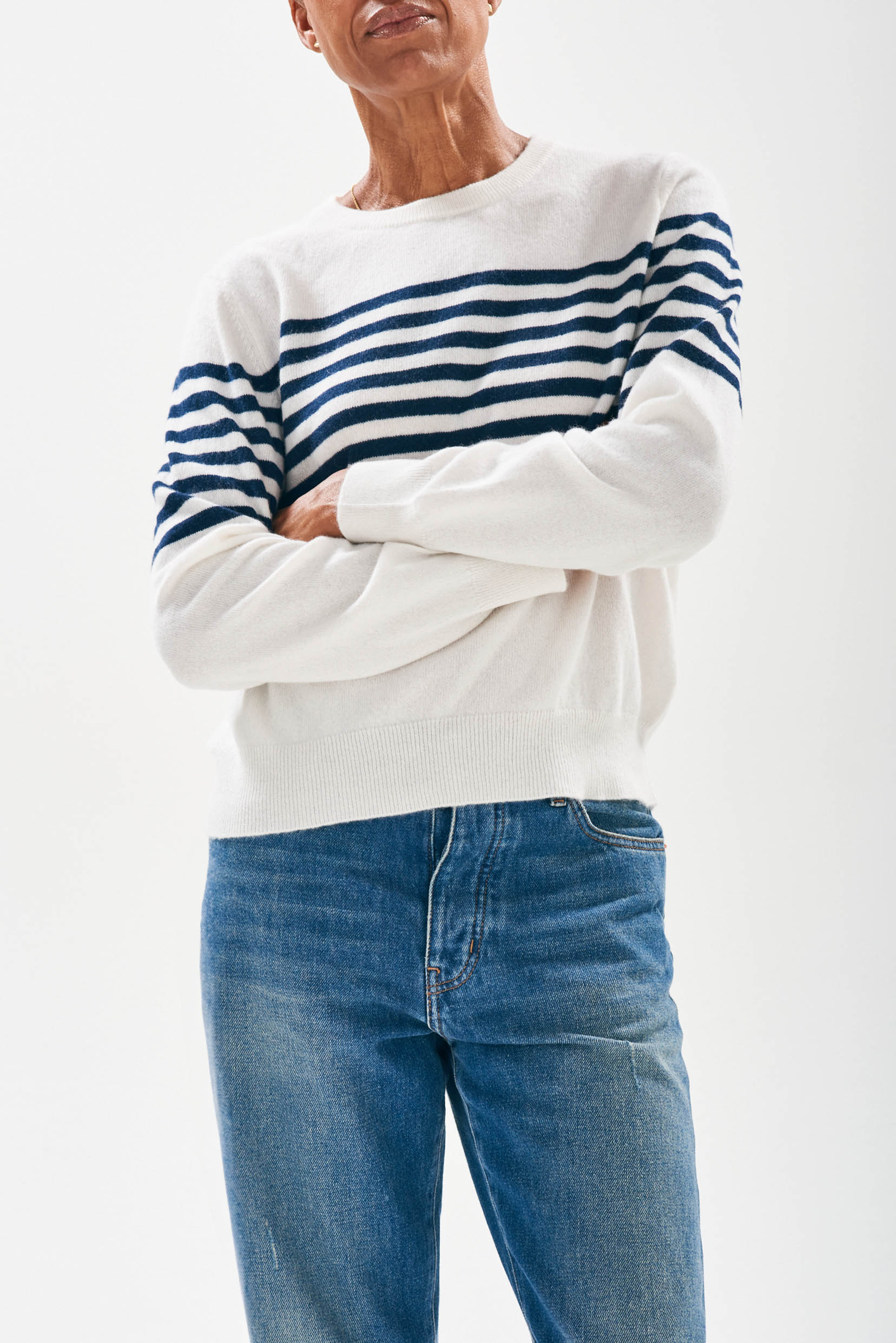 Model wearing Jumper1234 Cream cashmere crew neck jumper with navy stripe block running across the middle of the chest, with button detail at the back neck