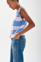 Model wearing Jumper1234 Deckchair stripe tank. Pale blue and sky striped cashmere crew neck tank with oatmeal ribs and a narrow tangerine stripe too facing sideways to the camera