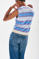 Model wearing Jumper1234 Deckchair stripe tank. Pale blue and sky striped cashmere crew neck tank with oatmeal ribs and a narrow tangerine stripe too facing away from the camera