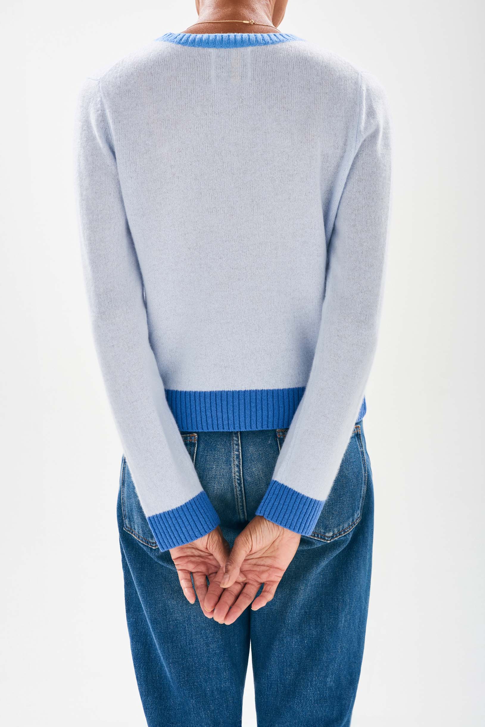 Model wearing Jumper1234 Pale blue cashmere crew neck jumper with contrast ribs in sky and cornflower facing away from the camera