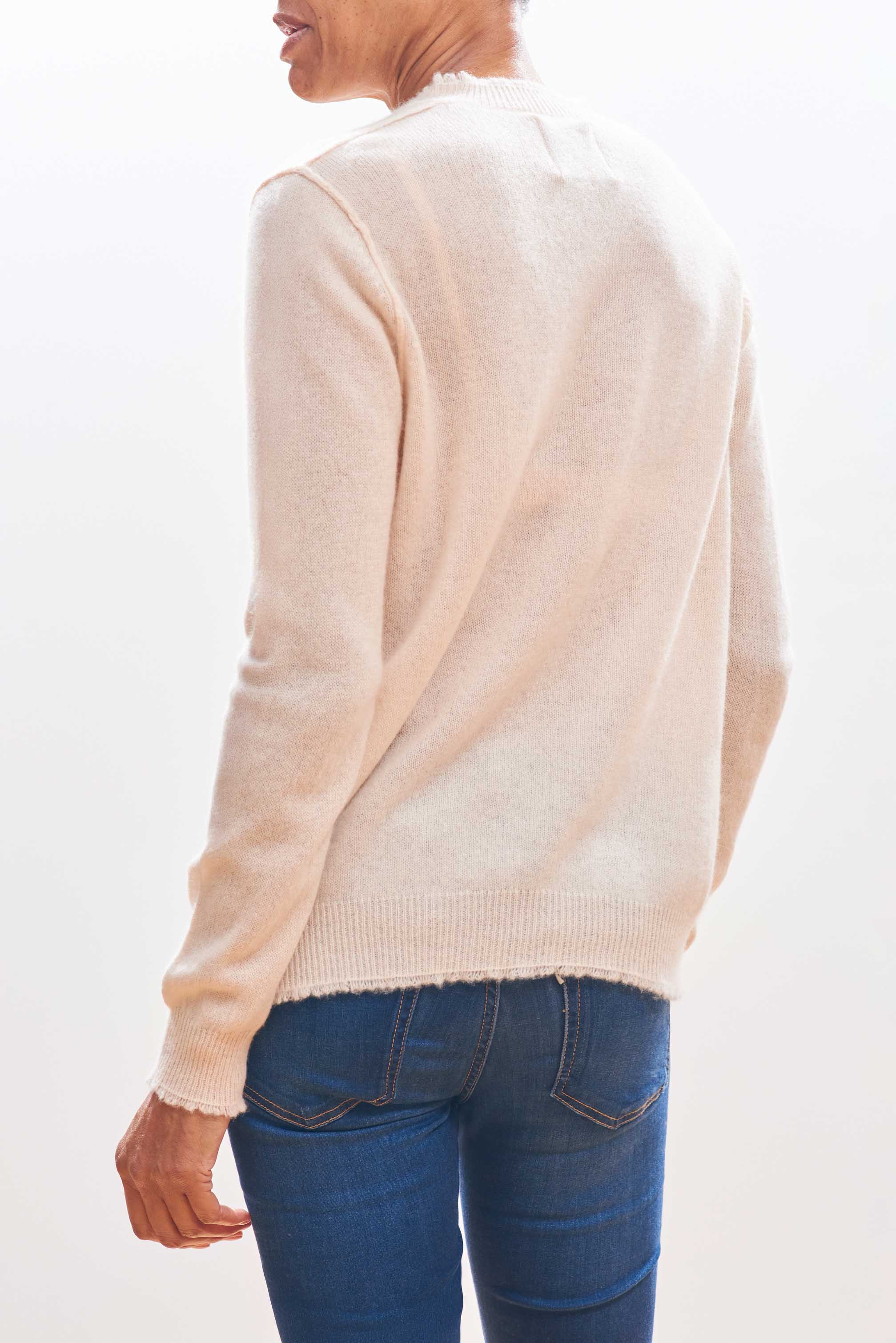 Model wearing Jumper1234 Cream cashmere crew neck with 'distressed' ribs facing away from the camera