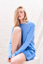 Female model wearing Jumper 1234 Blue cashmere crew neck with 'distressed' ribs.