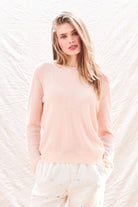 Female model wearing Jumper 1234 Pale pink cashmere crew neck with 'distressed' ribs.