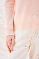 Jumper 1234 Pale pink cashmere crew neck with 'distressed' ribs. Close up sleeve rib detail.