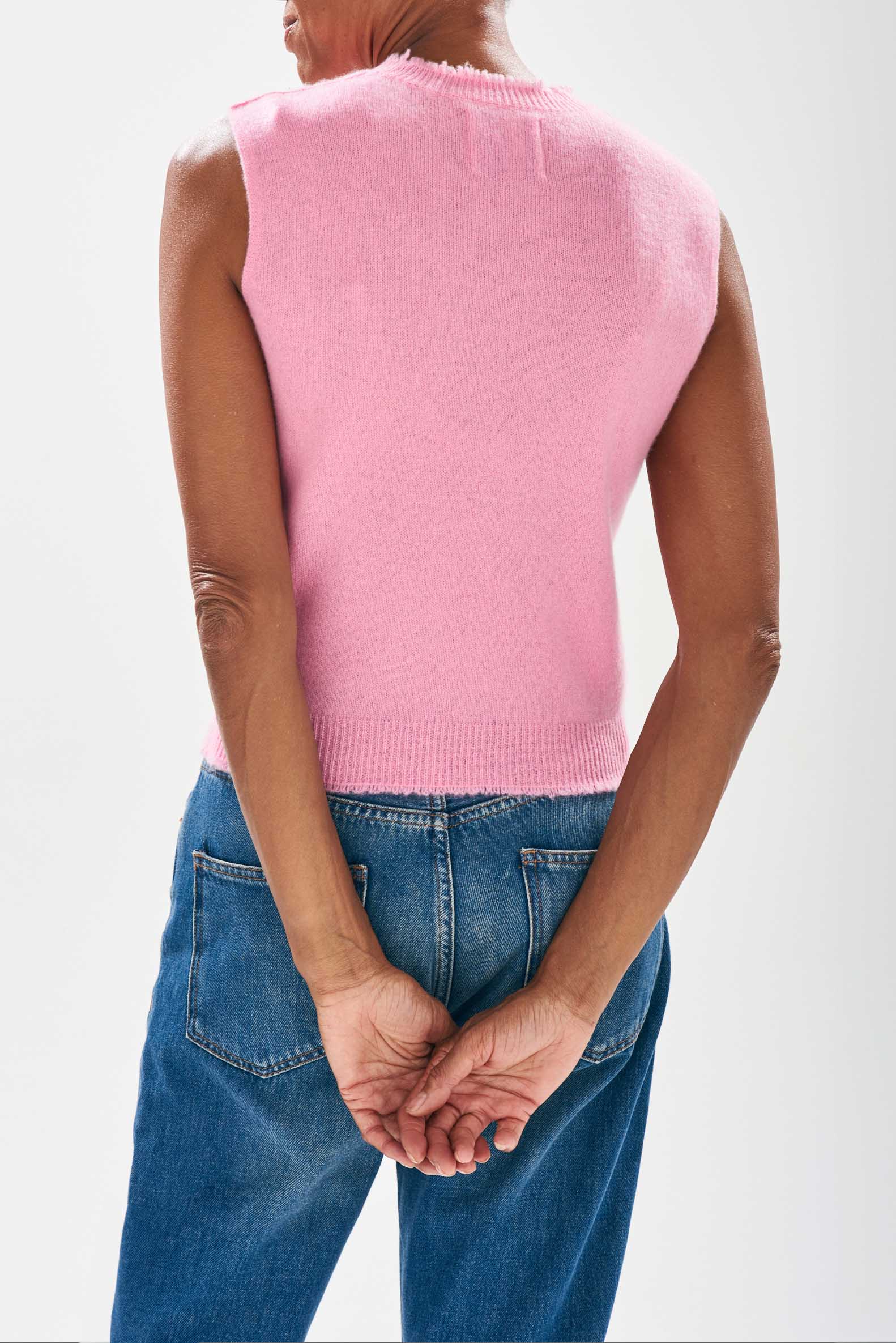 Model wearing Jumper1234 Candy pink cashmere crew neck tank with 'distressed' ribs facing away from the camera