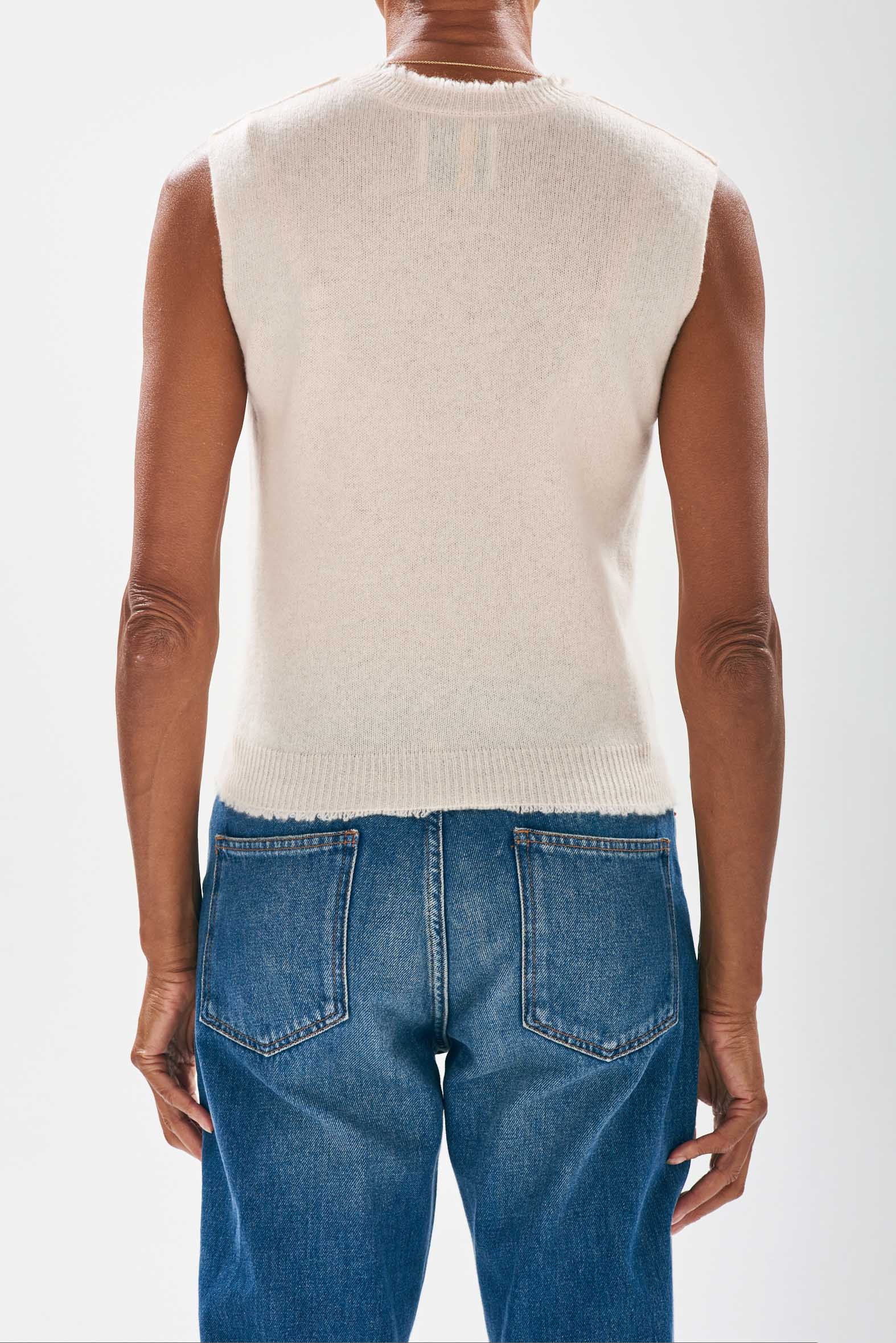 Model wearing Jumper1234 Cream cashmere crew neck tank with 'distressed' ribs facing away from the camera