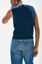 Model wearing Jumper1234 Navy cashmere crew neck tank with 'distressed' ribs facing away from the camera