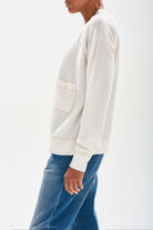 Jumper1234  Cream boyfriend vee neck cashmere cardigan with organic light brown top stitching detail and a pocket stood sideways 