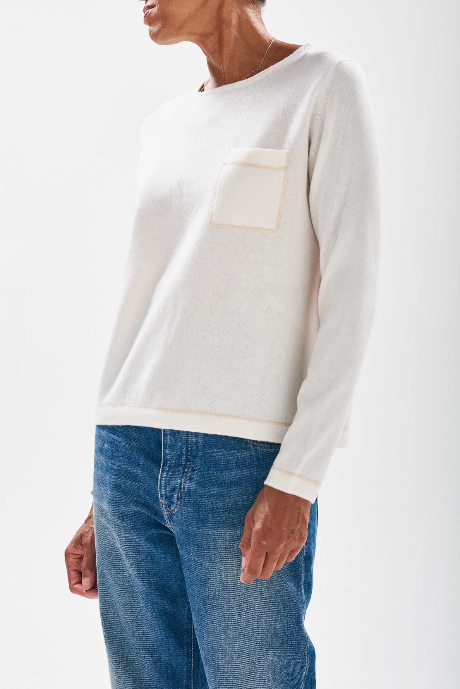 Model wearing Jumper1234 Cream cashmere crew neck jumper with organic light brown top stitching detail and a chest pocket