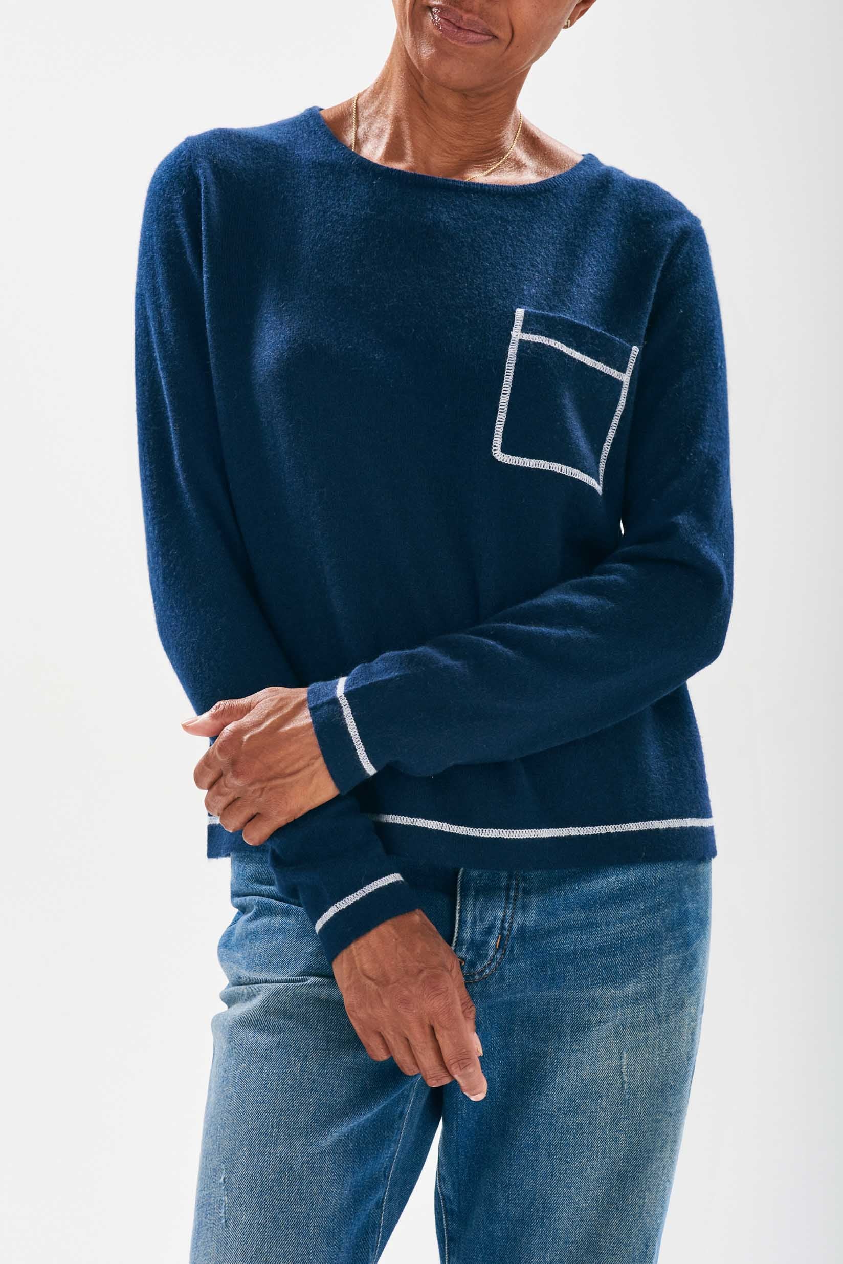 Model wearing Jumper1234 Navy cashmere crew neck jumper with cream top stitching detail and a chest pocket
