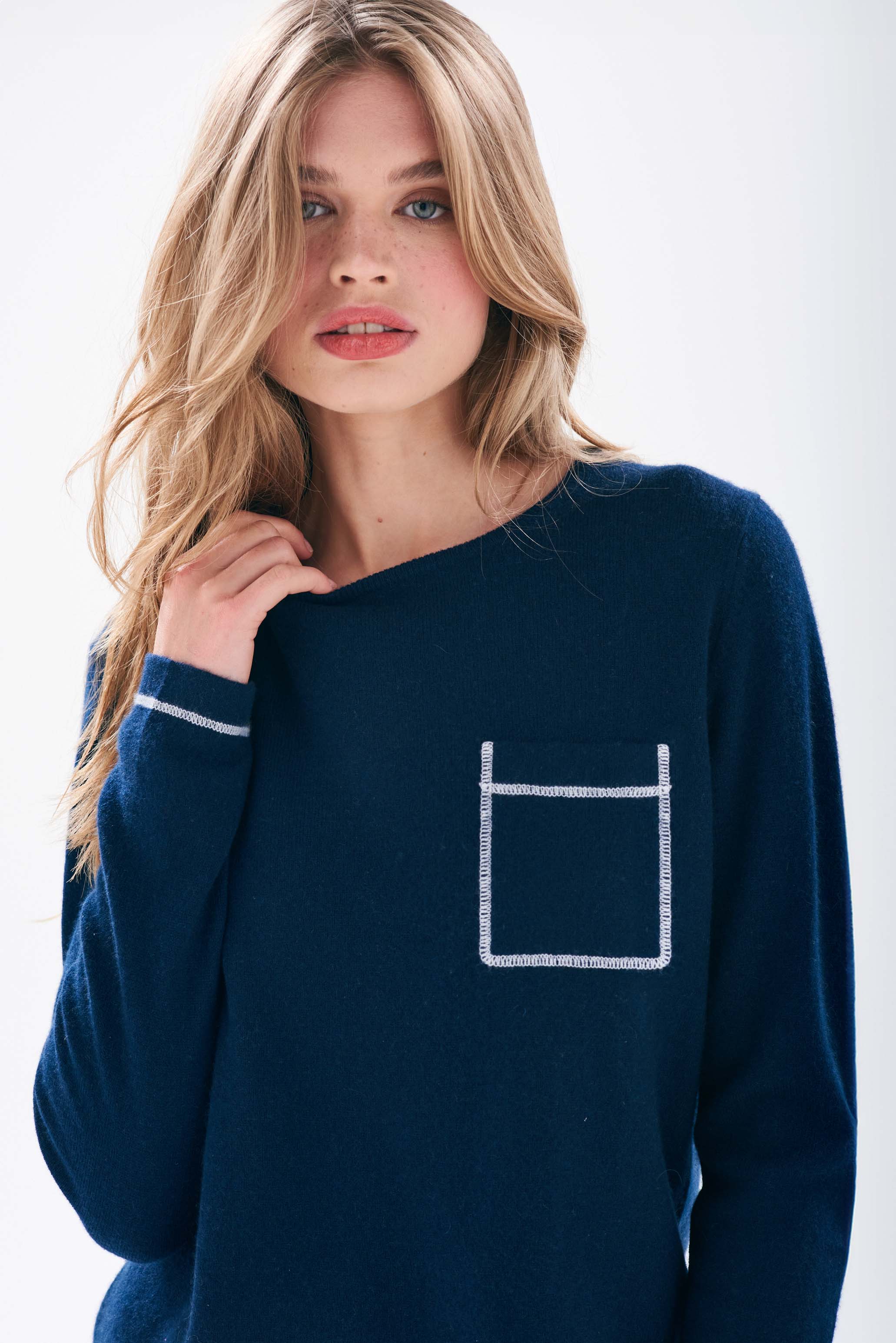 Model wearing Jumper1234 Navy cashmere crew neck jumper with cream top stitching detail and a chest pocket