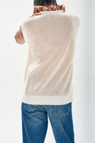 Model wearing Jumper1234 Oversize mesh cashmere tank in cream with contrast white ribs, slightly longer at the back facing away from the camera