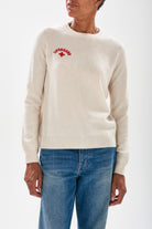 Model wearing Jumper1234 Oatmeal cashmere crew neck jumper with red embroidered lifeguard detail