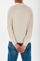 Jumper1234 Oatmeal cashmere crew neck jumper with red embroidered lifeguard detail facing away from the camera
