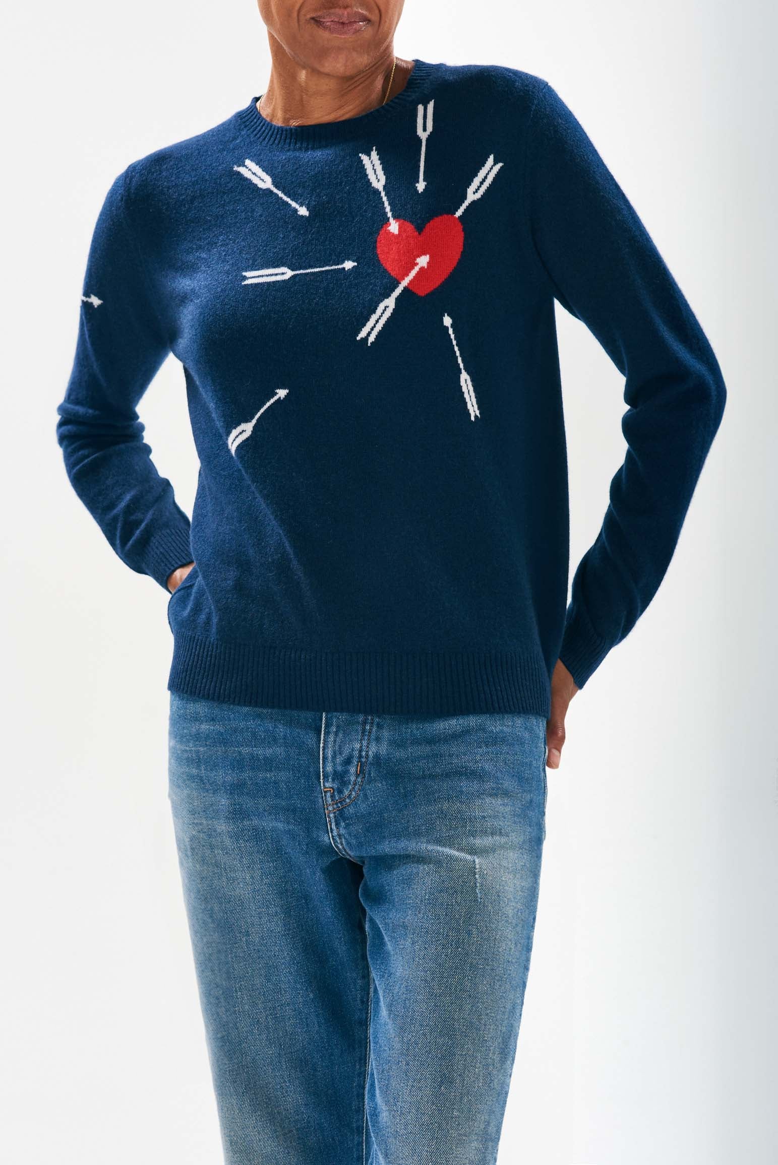 Model wearing Jumper1234 Navy cashmere crew neck jumper with heart and arrows intarsia in red and cream