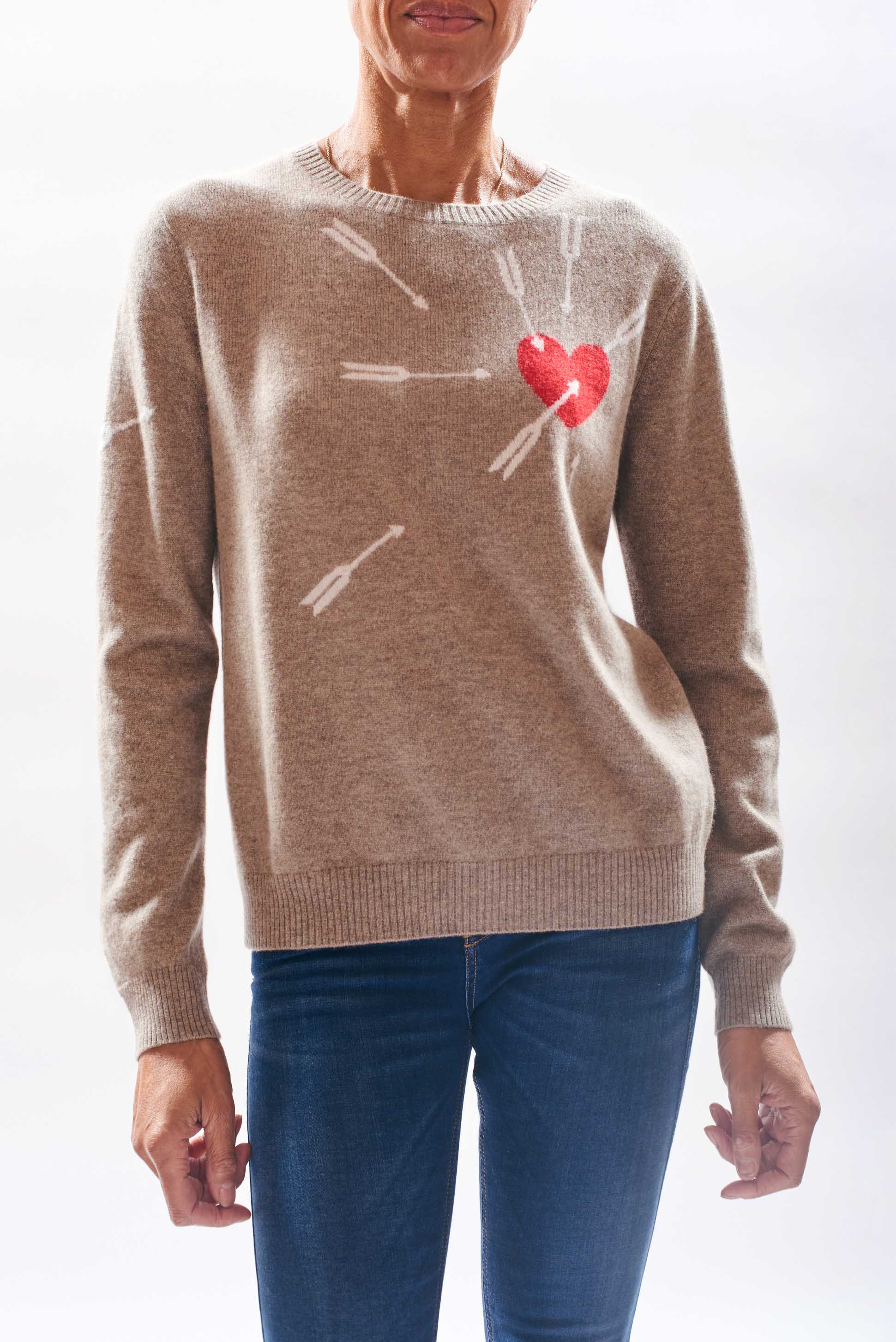 Model wearing Jumper1234 Organic light brown cashmere crew neck jumper with heart and arrows intarsia in red and cream