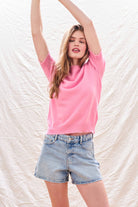 Female model wearing Jumper 1234 Candy pink short sleeve cashmere jumper with 'distressed' ribs.