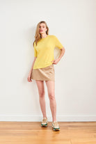 Female model wearing Jumper 1234 Yellow short sleeve cashmere jumper with 'distressed' ribs.
