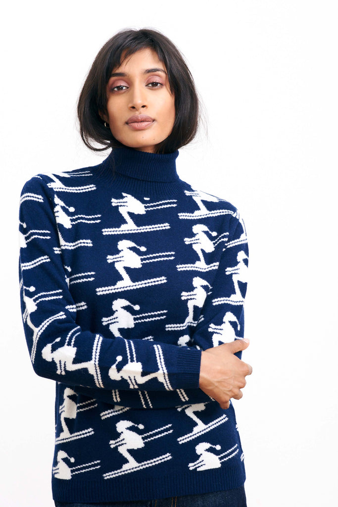 Brown haired female model wearing Jumper1234 navy cashmere and wool roll neck with all over cream jacquard skier