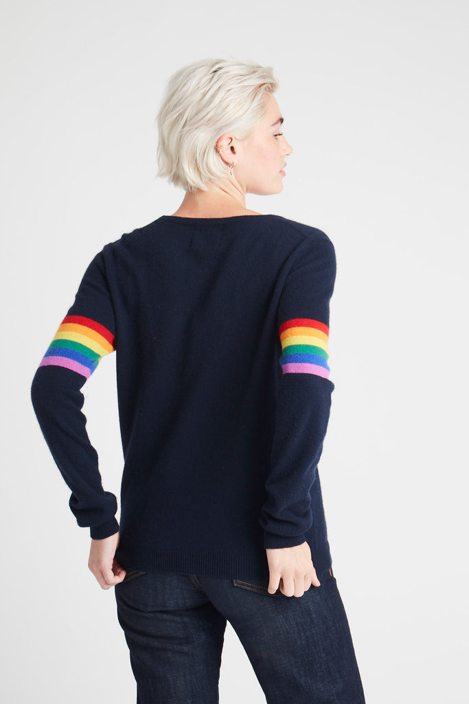 Blonde female model facing away from camera wearing Jumper1234 Rainbow Stripe Sleeve Cashmere Sleeve in Navy