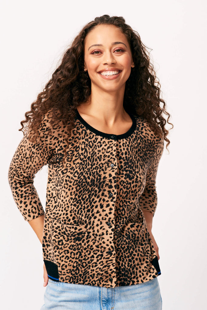 Brown haired female model smiling wearing Jumper 1234 cashmere wool blend leopard print cashmere cardigan